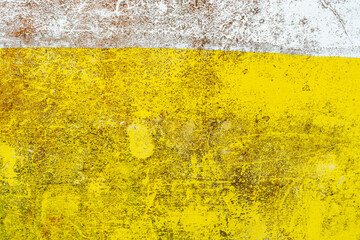 Bright yellow concrete wall texture with white horizontal stripe