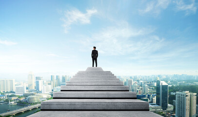 Success person climbed on top of the stairs looking at the cityscape. Success business concept.