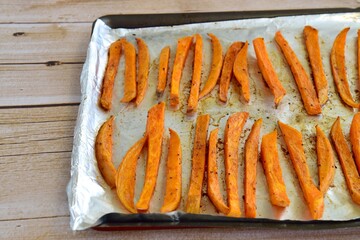Sweet potato fries on baking sheet fresh from the oven