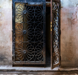 Fototapeta na wymiar Window with decorative security bars in Morocco 