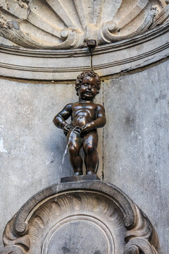 Brussels, Belgium  - January 17, 2015: Manneken Pis statue in Brussels. Statue of a pissing boy in a beautiful summer day