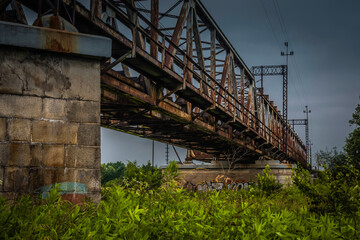 Fototapeta na wymiar Colorful graffiti under the iron railway bridge.