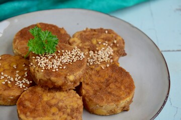 Slices of tempeh (fermented soybean) on the wooden board