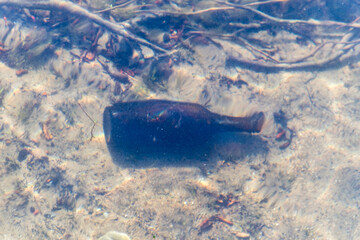 Bottle under the water in the lake.