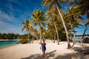 girl posing in tropical beach with palm trees