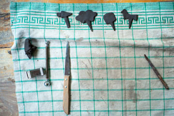 Aerial view of tools on the dirty piece of cloth with artwork of molding clay in the workshop class with copy space for adding some text