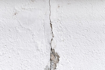 Cracked wall . Plaster and paint clog, structural damage, water damage or frost damage