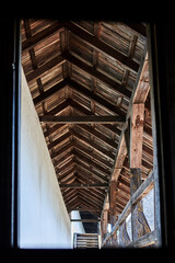 Wooden roof over the balcony in an old building.