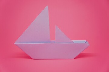 paper boat on pink background