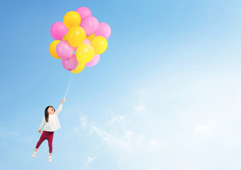 Fototapeta na wymiar Adorable asian toddler hand holding balloon flying to the sky.