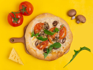 Vegetarian pizza with mushrooms, tomatoes and herbs. Ingredients. Notepad.