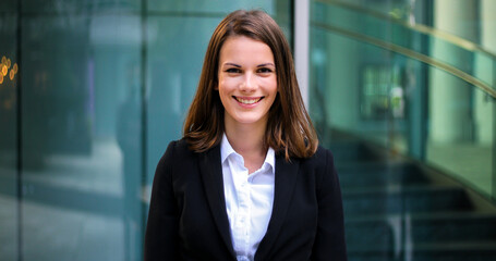 Confident young female manager outdoor in a modern urban setting