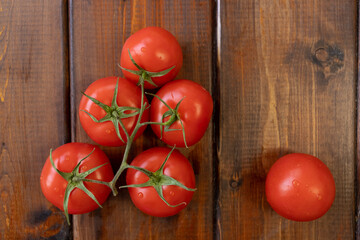 tomato on a brown wooden background, top view, text space, fresh vegetables