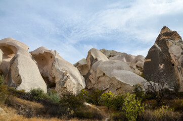 Beautiful landscape of ancient eroded white and pink sandstone rock formations in Cappadocia valley, Turkey