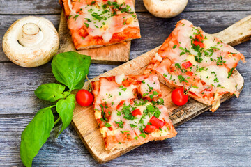  Assorted sliced italian roman   style pizza.  with parmesan cheese,  ham,  mushrooms and tomato sauce 