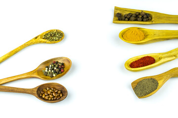 Spoons with spices and seasonings, with space for text, isolated on white background.