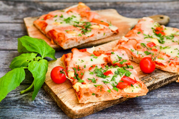 Fototapeta na wymiar Assorted sliced italian roman style pizza. with parmesan cheese, ham, mushrooms and tomato sauce 