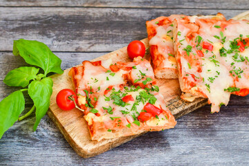  Assorted sliced italian roman   style pizza.  with parmesan cheese,  ham,  mushrooms and tomato sauce 
