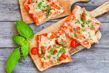  Assorted sliced italian roman   style pizza.  with parmesan cheese,  ham,  mushrooms and tomato sauce 