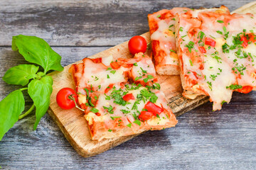  Assorted sliced italian roman   style pizza.  with parmesan cheese,  ham,  mushrooms and tomato sauce 