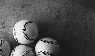 Baseball background in black and white with balls on texture backdrop and sport game copy space.