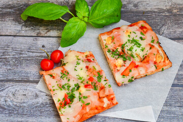  Assorted sliced italian roman   style pizza.  with parmesan cheese,  ham,  mushrooms and tomato sauce 