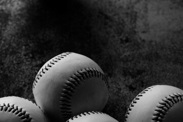 baseballs on black texture background