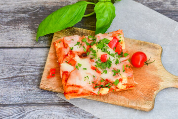  Assorted sliced italian roman   style pizza.  with parmesan cheese,  ham,  mushrooms and tomato sauce 