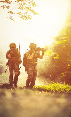 	
Team special forces. soldier assault rifle with silencer. sniper in the forest.