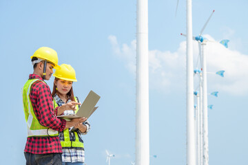 Two Engineers asian in a Wind Turbine Power Station,Renewable energy concepts