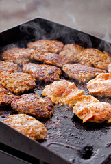 Sausages cooking at an outdoor summer event