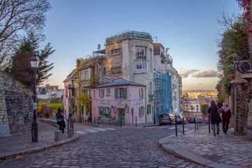 Beautiful old street with pink house at the sunrise in Paris, France
