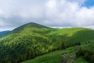 Obraz premium Green ridge in mountain and blue cloud sky. Composition of nature. Spring ountain. Composition of nature. Slovakia little fatra europe