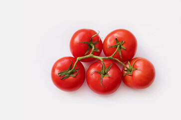 branch of red tomato on a white background top view