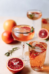 Summer cocktail with blood orange, grapefruit and rosemary