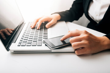 Fototapeta premium businesswoman hand using smart phone, tablet payments and holding credit card online shopping, omni channel, digital tablet docking keyboard computer at office in sun light