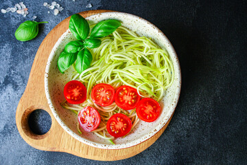zucchini spaghetti salad tomato vegetables Menu concept serving size. food background top view copy space organic healthy eating keto or paleo diet