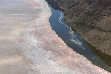 Aerial view of the salt pan and mineral crust with red algae of Lake Magadi, in the Great Rift Valley, on the border between Kenya and Tanzania. The Rift Valley contains a chain of active volcanoes.