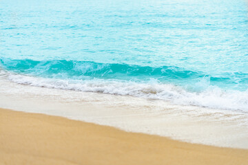 Fototapeta na wymiar close up sand beach with blue sea wave background