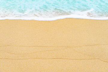 Fototapeta na wymiar close up sand beach with blue sea wave background