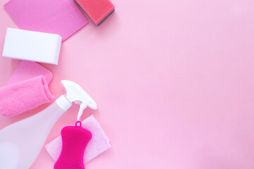 Detergents and cleaning products agent, sponges, napkins and rubber gloves, pink background. Top view. Copy space