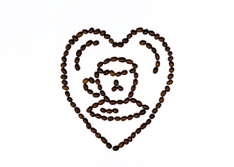 Cup of coffee in the middle of the heart. The composition is  made of roasted beans on the white blackground.