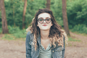 
Portrait of a girl in glasses in the woods