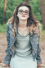 
Portrait of a girl in glasses in the woods