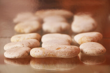Gray sea stones on a glass table.
