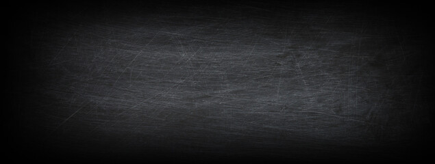 Dark, grunge and scratched black texture may used as background