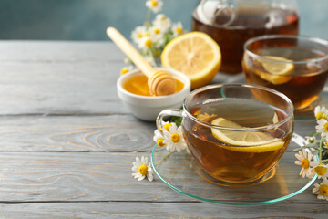 Composition with chamomile tea on gray wooden background