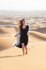 Cheerful free girl runs in the desert. The joy of freedom, the concept of a free happy life away from city life