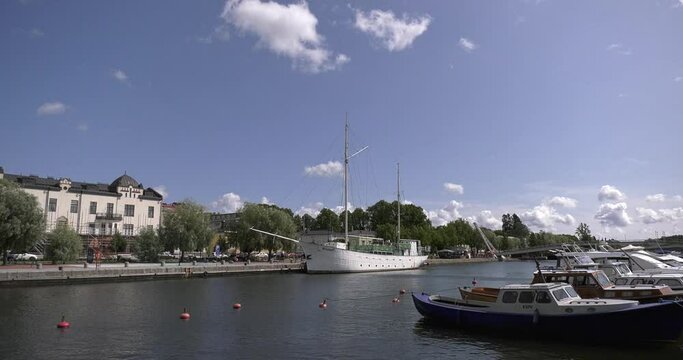 4K video of Porvoo vintage red wooden buildings, Porvoo Cathedral, yachts and boats in Porvoonjoki River near town center on sunny summer day in Finland, northern Europe
