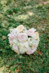 Beautiful wedding bouquet for the bride with pink peonies and white peony roses